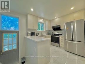 Richmond Hill (Crosby) apartment for rent - A white kitchen with a refrigerator, sink, and stove.