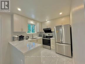 Richmond Hill (Crosby) apartment for rent - A white kitchen with a refrigerator, sink, and stove.