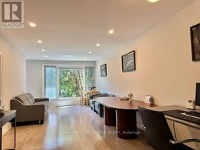 Richmond Hill (Crosby) apartment for rent - A well-lit office space with a desk, chairs, and a computer.