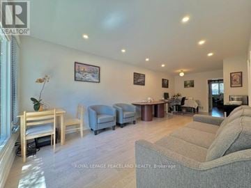 Richmond Hill (Crosby) apartment for rent - A living room with a grey couch and wooden furniture.