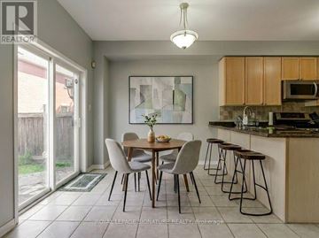 Richmond Hill (Oak Ridges Lake Wilcox) apartment for rent - A dining room with a table set for two and a kitchen area with a microwave and oven.