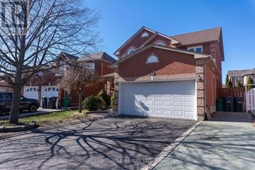 Brampton (Fletcher's West) apartment for rent - A large red brick house with a white garage door in front.