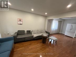 Brampton (Fletcher's West) apartment for rent - A living room with a grey couch and a blue chair.