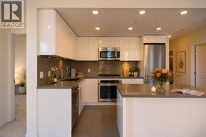 Burnaby apartment for rent - A modern kitchen with white cabinets and stainless steel appliances.