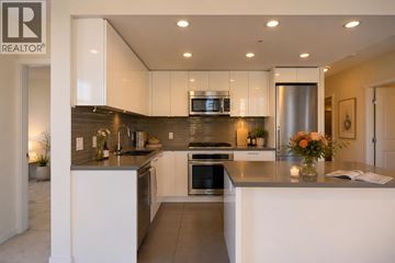 Burnaby apartment for rent - A modern kitchen with white cabinets and stainless steel appliances.
