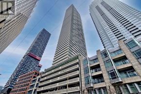Toronto (Mount Pleasant West) condo for rent - A tall building with the words "Loyalty Real Estate" on its side is seen from below.