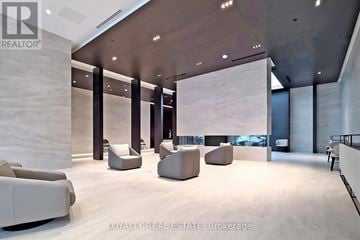 Toronto (Mount Pleasant West) condo for rent - A modern living room with white furniture and a large window.