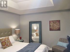 Toronto (Mimico) apartment for rent - A bedroom with a bed, chair, and painting.
