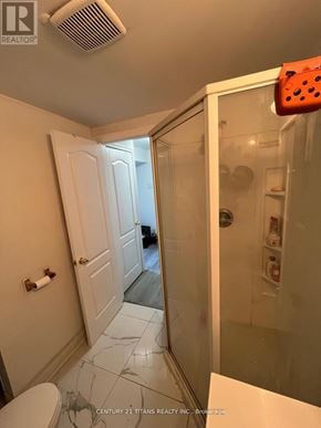 Whitby (Pringle Creek) apartment for rent - A bathroom with a toilet, a shower, and a door.