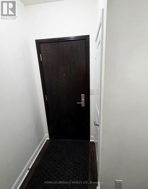 Mississauga (City Centre) condo for rent - A dark brown door in a white hallway.