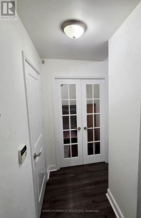 Mississauga (City Centre) condo for rent - A hallway with a white door and a light on the ceiling.