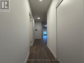 Burlington (Alton) condo for rent - A long hallway with a door at the end.