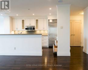 Toronto (Church-Yonge Corridor) condo for rent - A kitchen with white cabinets and a stainless steel refrigerator.