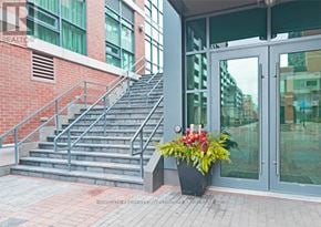 Toronto (Little Portugal) condo for rent - A flower pot is placed in front of a glass door.