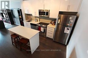 Toronto (Little Portugal) condo for rent - A kitchen with a white counter top and a refrigerator.