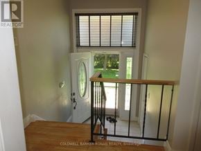 New Tecumseth (Alliston) apartment for rent - A view from the top of a staircase looking down at a balcony.