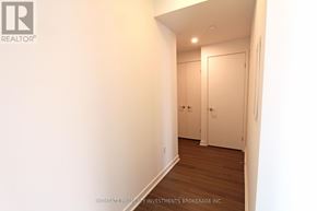 Toronto (Waterfront Communities) condo for rent - A hallway with a door on the right and a wall on the left.