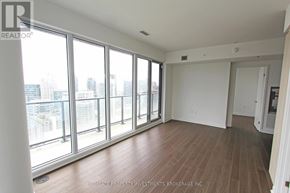 Toronto (Waterfront Communities) condo for rent - A room with a view of the city through large windows.