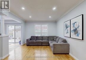 Whitby (Williamsburg) duplex for rent - A living room with a grey couch and a painting on the wall.
