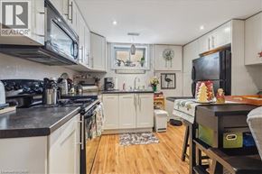 Hamilton apartment for rent - A kitchen with white cabinets and black countertops.