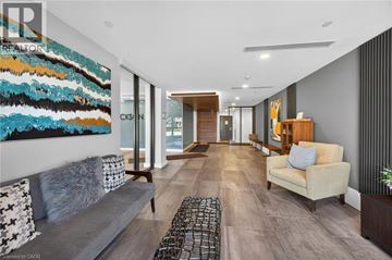 Hagersville condo for rent - A modern living room with a large abstract painting on the wall.