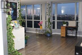 Toronto (Mount Olive-Silverstone-Jamestown) condo for rent - A room with a view of the city at night through the windows.