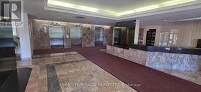 Toronto (Mount Olive-Silverstone-Jamestown) condo for rent - A reception area with a marble floor and a stone wall.