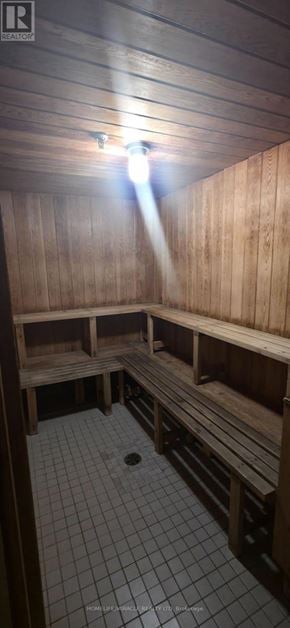 Toronto (Mount Olive-Silverstone-Jamestown) condo for rent - A wooden sauna with benches and a light shining through the ceiling.