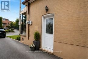 Toronto (Keelesdale-Eglinton West) apartment for rent - A house with a white door and a small plant in front of it.
