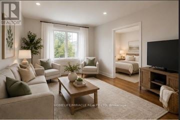 Toronto (Keelesdale-Eglinton West) apartment for rent - A well-lit living room with a grey sofa, a wooden coffee table, and a television.