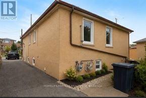 Toronto (Keelesdale-Eglinton West) apartment for rent - A small house with a brown roof and a black trash bin in front.