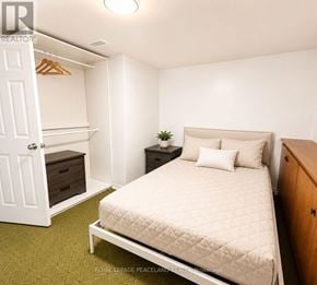 Hamilton (Westcliffe) apartment for rent - A bedroom with a bed, nightstand, and wardrobe.
