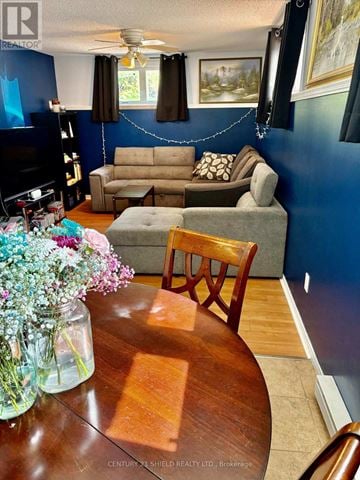 Russell condo for rent - A living room with a brown couch and a wooden table.