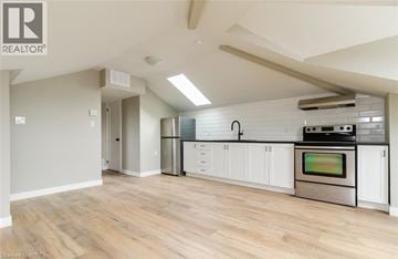 Brantford apartment for rent - A kitchen with white cabinets and a stainless steel oven.