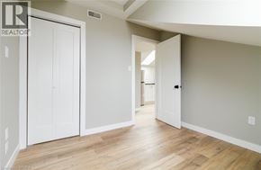 Brantford apartment for rent - A room with a white door and a wooden floor.