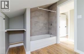 Brantford apartment for rent - A bathroom with a tub and a walk-in shower.