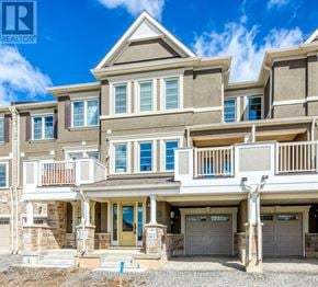 Oakville (Go Glenorchy) townhouse for rent - A large, multi-level house with a balcony and a garage.