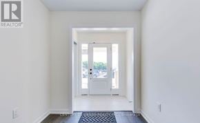 Oakville (Go Glenorchy) townhouse for rent - A hallway with a door leading to a balcony.