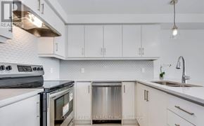Oakville (Go Glenorchy) townhouse for rent - A kitchen with white cabinets and a stainless steel dishwasher.