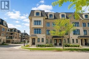 Oakville (Ro River Oaks) townhouse for rent - A large, multi-story building with a mix of stone and siding exterior, surrounded by a well-maintained lawn and trees.