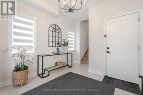 Oakville (Ro River Oaks) townhouse for rent - A hallway with a bench and a chandelier.