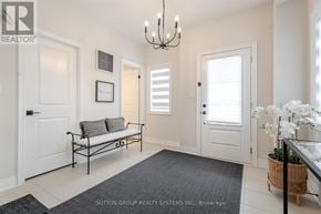 Oakville (Ro River Oaks) townhouse for rent - A white hallway with a bench and a chandelier.