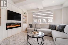 Oakville (Ro River Oaks) townhouse for rent - A modern living room with a fireplace and a couch.