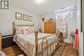 Hamilton (Huntington) apartment for rent - A bedroom with a bed, dresser, and a window with curtains.