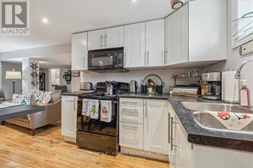 Hamilton (Huntington) apartment for rent - A kitchen with white cabinets and a black stove top oven.