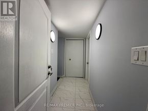 St. Catharines (Fairview) apartment for rent - A hallway with a door at the end and a light switch on the wall.