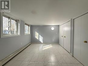 St. Catharines (Fairview) apartment for rent - A spacious room with white cabinets and a marble floor.