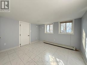 St. Catharines (Fairview) apartment for rent - A room with a white tile floor and a window with a white frame.