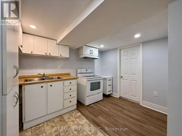 St. Catharines (Fairview) apartment for rent - A kitchen with white cabinets and a wooden countertop.