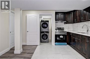 Cambridge apartment for rent - A modern kitchen with dark wood cabinets and a white door.